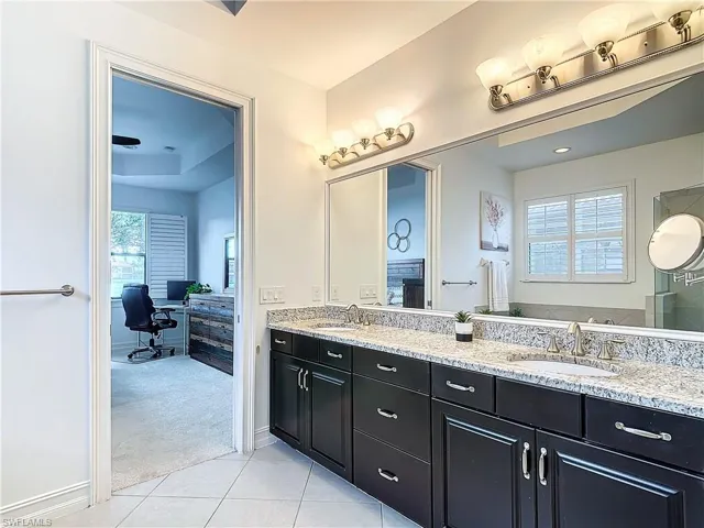 Bathroom featuring double vanity and tile patterned floors