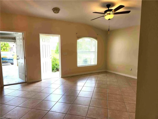 Spare room with light tile patterned floors and a ceiling fan