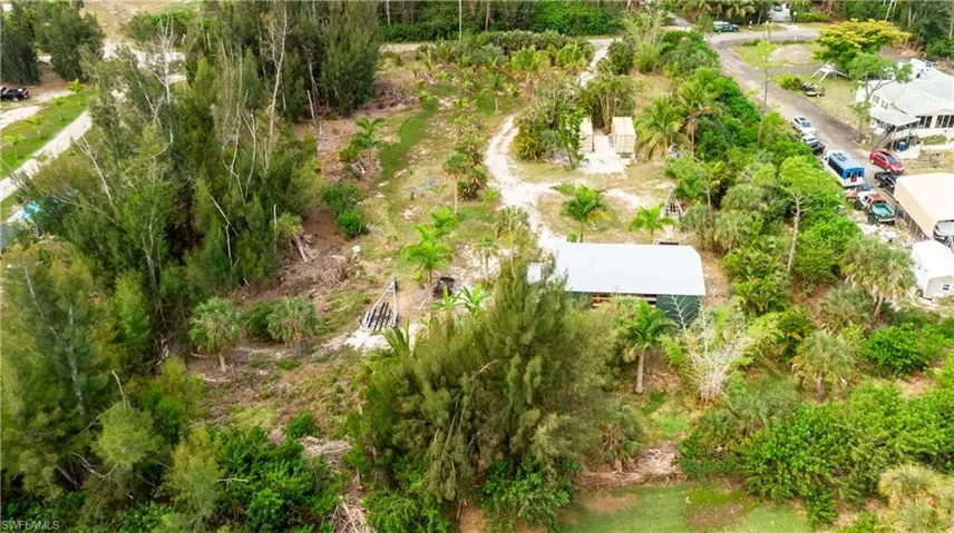 Northeast view of both properties behind barn showing lush greenery planted with room for more if desired.