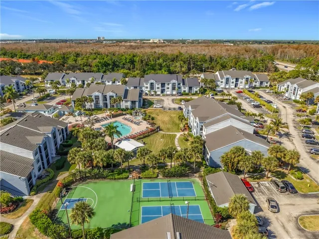 Aerial view of a heavily wooded area and a pool