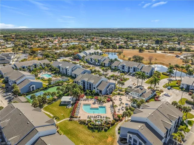 Aerial view of property and surrounding area with nearby suburban area and a nearby body of water