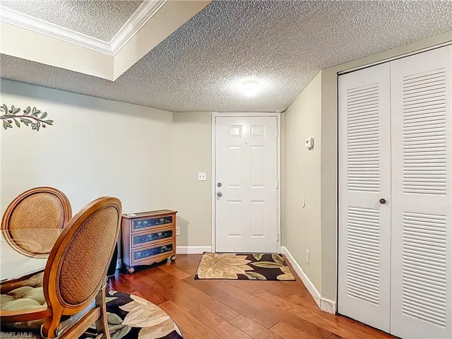 Office with hardwood / wood-style floors and a textured ceiling
