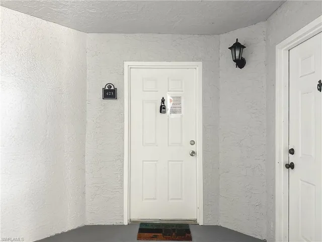 Property entrance with stucco siding