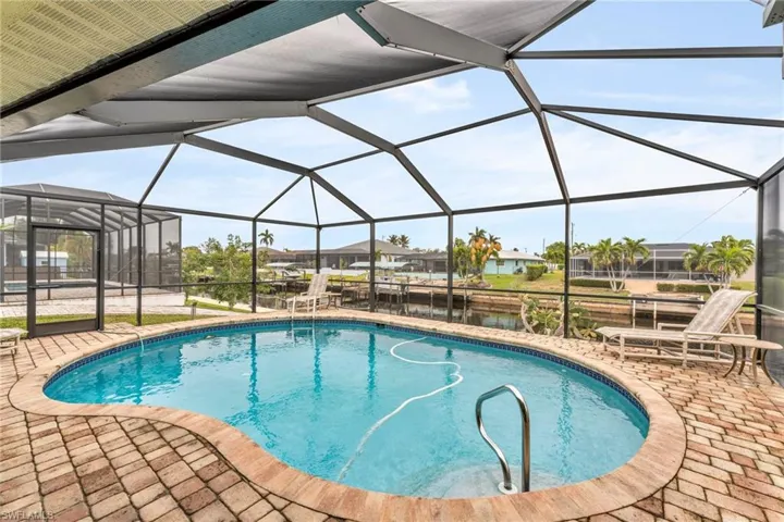 View of pool with a lanai and a patio area