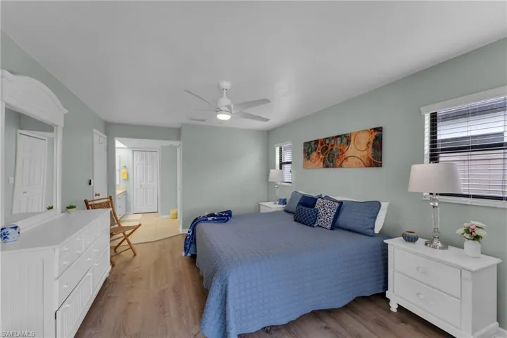 Bedroom with ceiling fan and hardwood / wood-style flooring