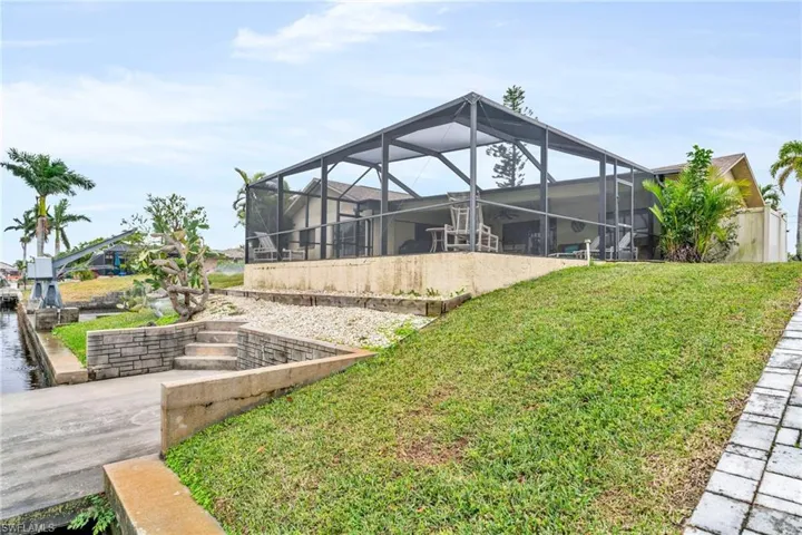 View of yard featuring glass enclosure