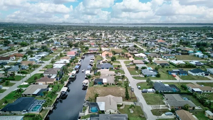 Birds eye view of property with a water view