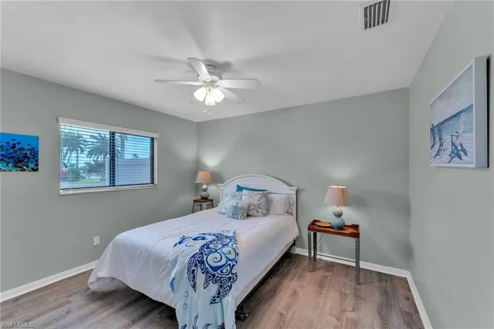 Bedroom featuring ceiling fan and hardwood / wood-style floors
