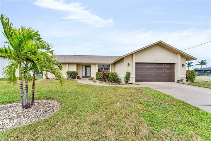 Single story home with a front yard and a garage