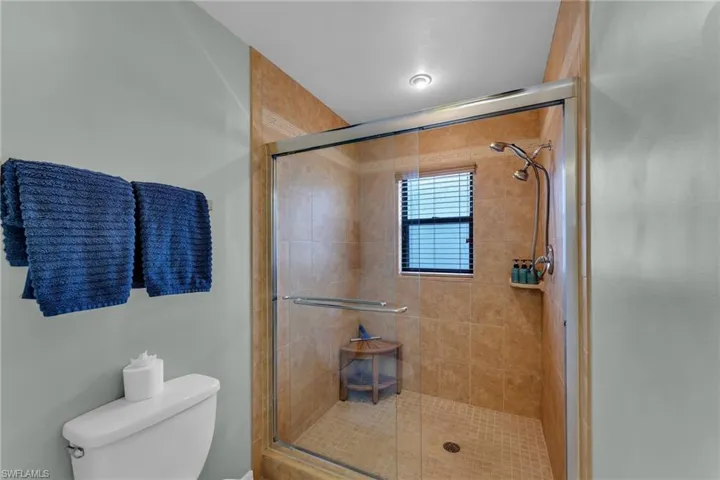 Bathroom featuring toilet and an enclosed shower