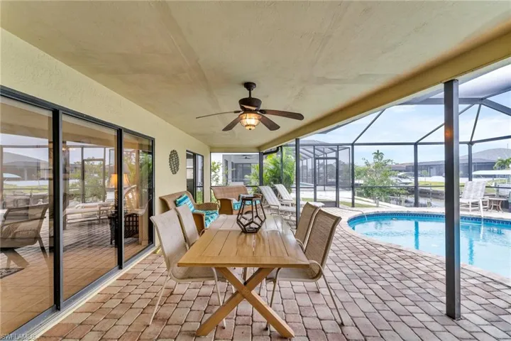 Sunroom / solarium featuring a swimming pool and ceiling fan
