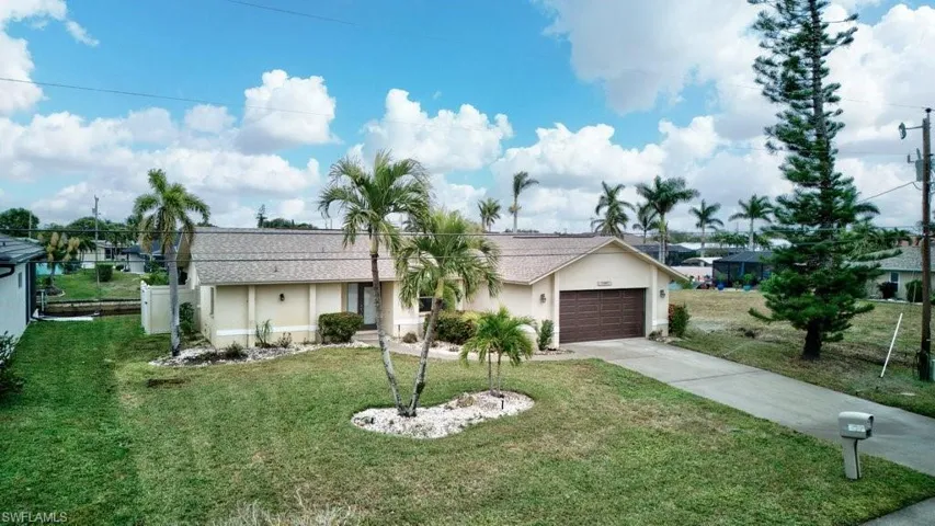 Ranch-style house with a front lawn and a garage