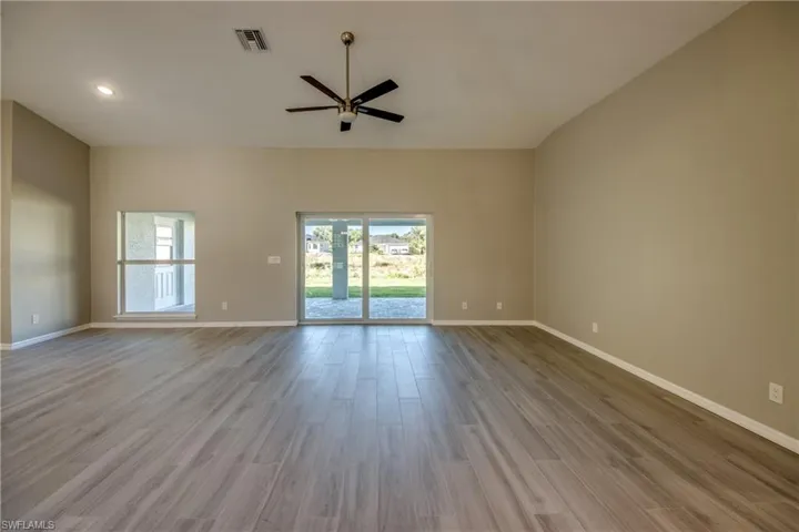 Spare room featuring light wood-type flooring and ceiling fan