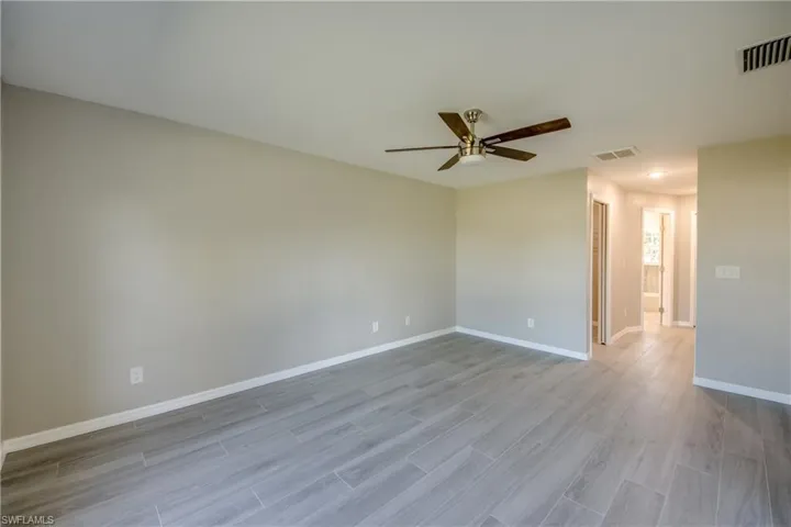 Spare room with wood finish floors and a ceiling fan