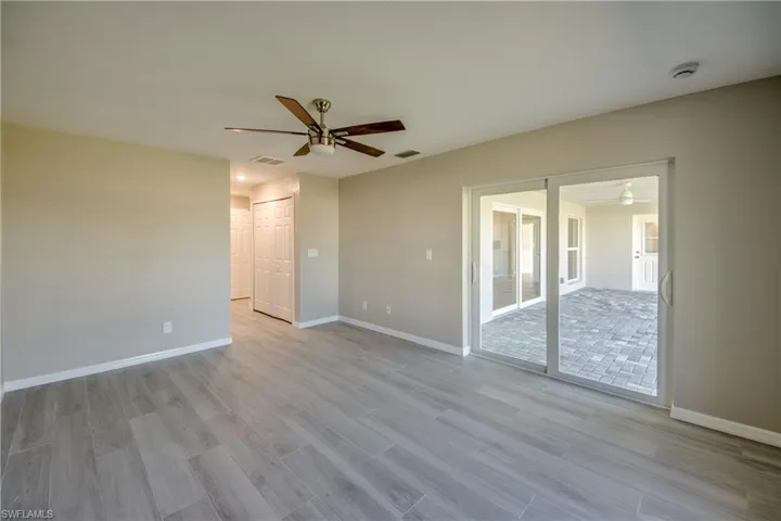 Spare room with a ceiling fan and wood tiled floors