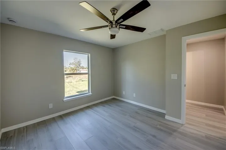 Spare room featuring light wood-style flooring and a ceiling fan