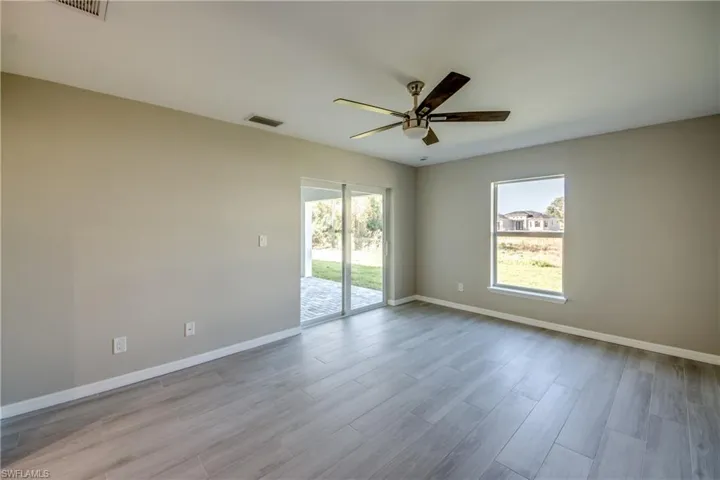 Unfurnished room featuring wood finish floors and a ceiling fan