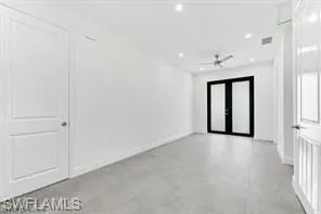 Hallway with baseboards and recessed lighting