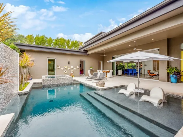 View of pool with an in ground hot tub, ceiling fan, and a patio area