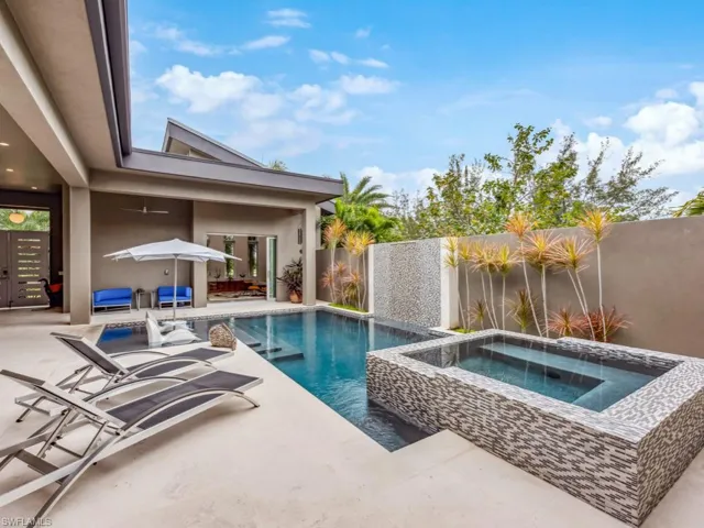 View of pool featuring a patio area and an in ground hot tub
