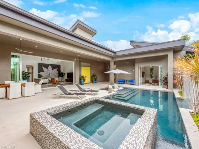 View of pool with a patio, ceiling fan, and an in ground hot tub