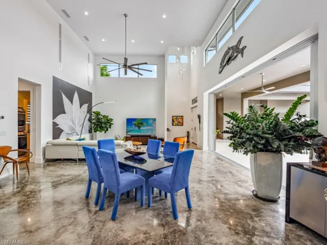 Dining space with ceiling fan and a towering ceiling
