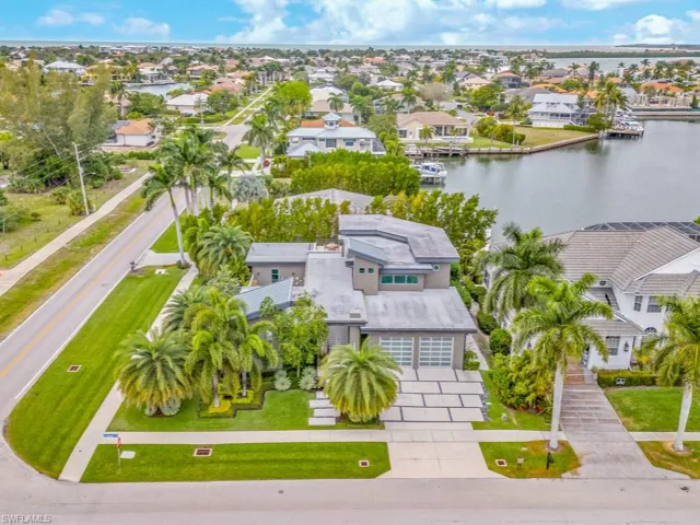 Birds eye view of property with a water view