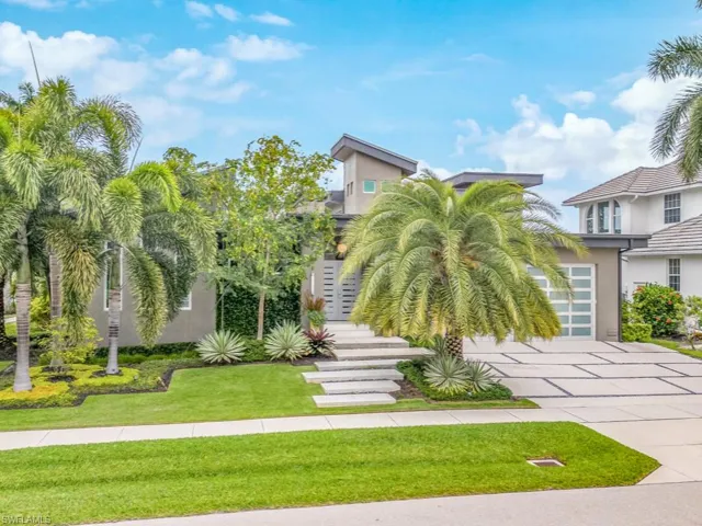 View of front of home with a garage and a front yard