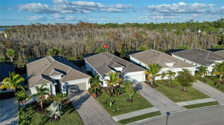Aerial perspective of suburban area featuring a forest