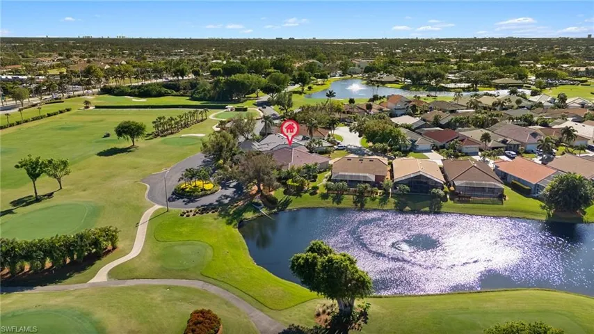 Birds eye view of property with a water view