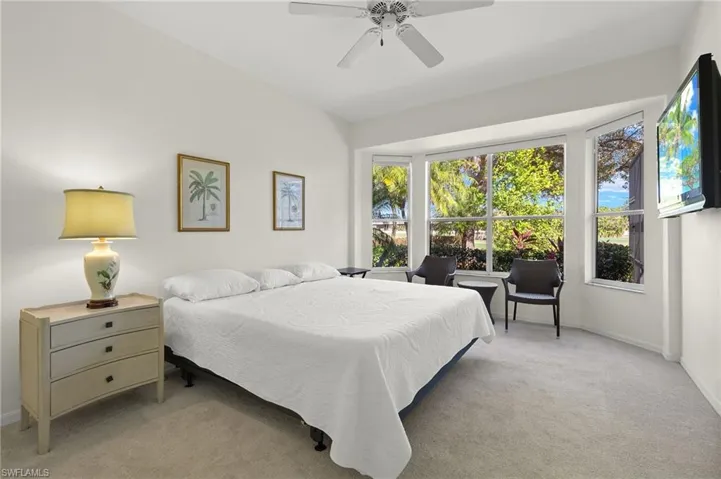 Carpeted bedroom with ceiling fan