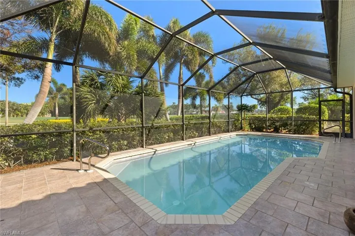 View of pool with a lanai and a patio area