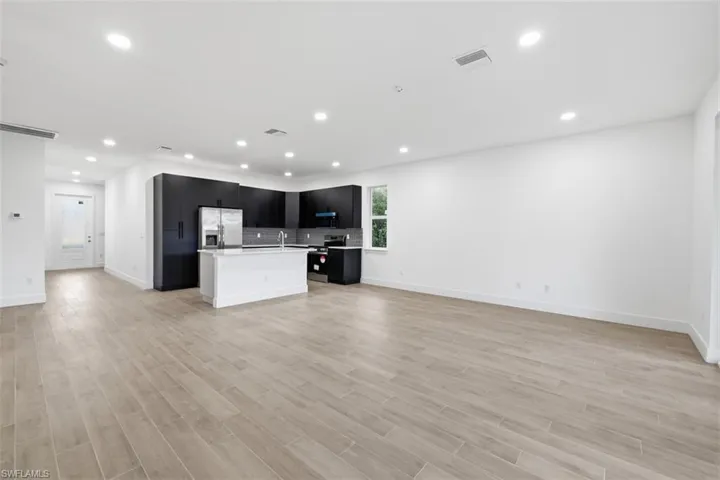 Open-concept living space with wood-finish flooring