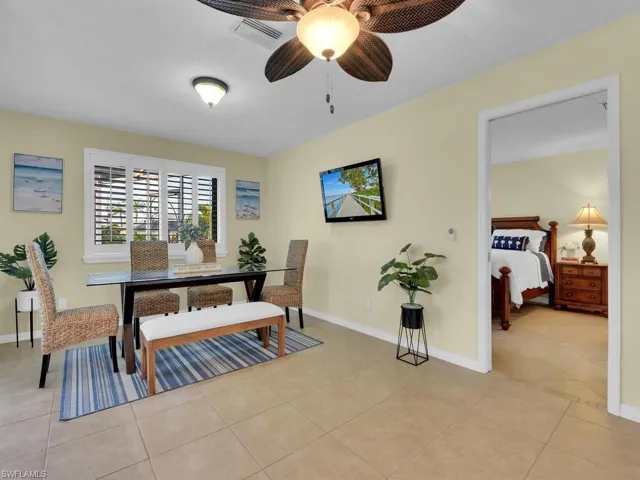 Tiled dining area featuring ceiling fan