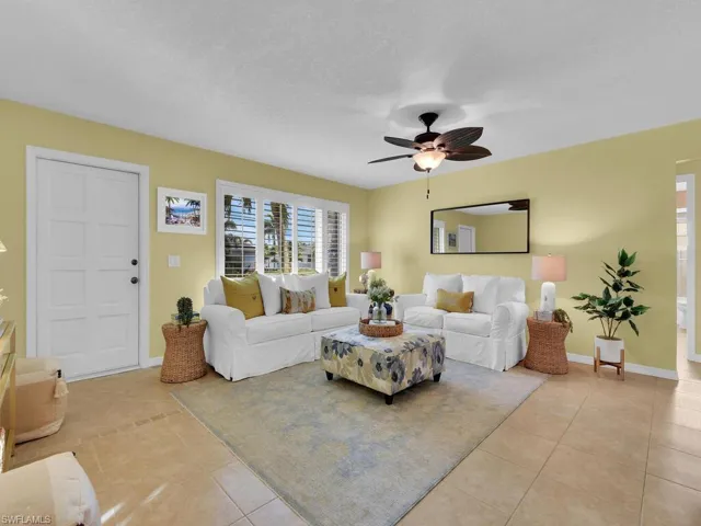 Tiled living room featuring ceiling fan