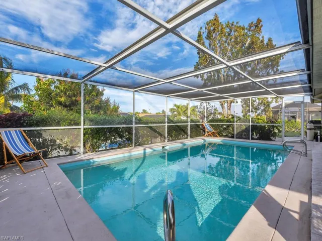 View of swimming pool with a lanai and a patio
