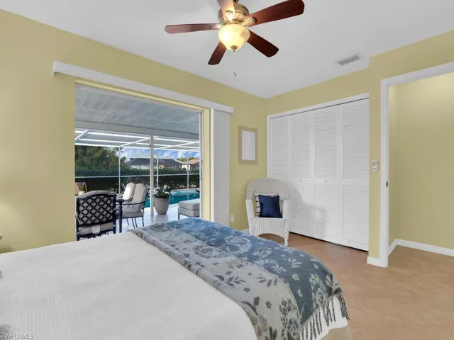Bedroom with ceiling fan, a closet, and tile patterned floors