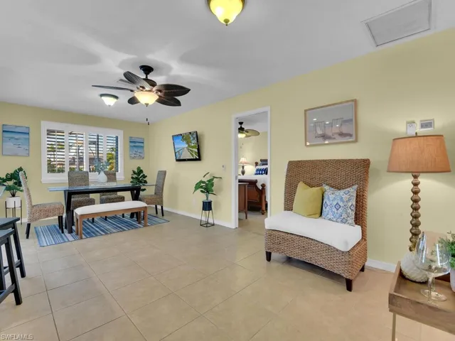 Living area featuring ceiling fan and light tile patterned floors