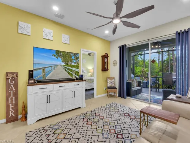 Living room featuring ceiling fan and light tile patterned floors
