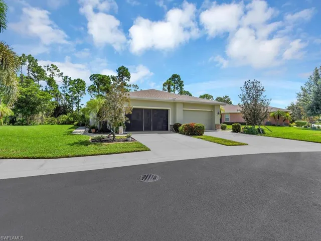 Ranch-style home with a garage and a front lawn