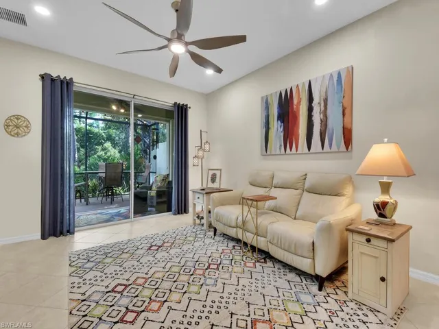 Tiled living room featuring ceiling fan