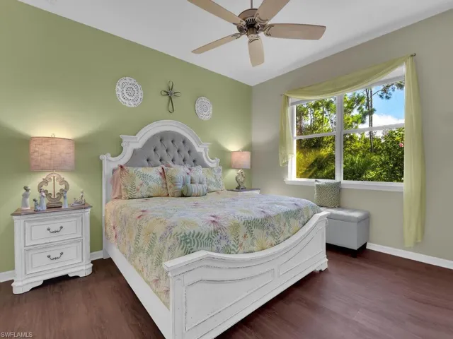 Bedroom featuring dark wood-type flooring and ceiling fan