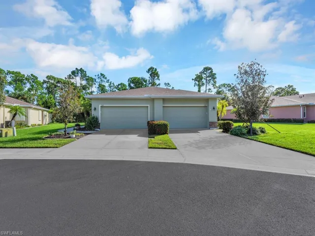 Ranch-style house with a garage and a front yard