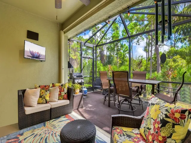 Sunroom with ceiling fan with notable chandelier