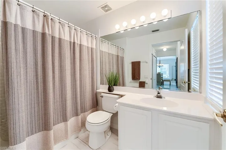 Full bathroom featuring visible vents, tile patterned flooring, vanity, and toilet