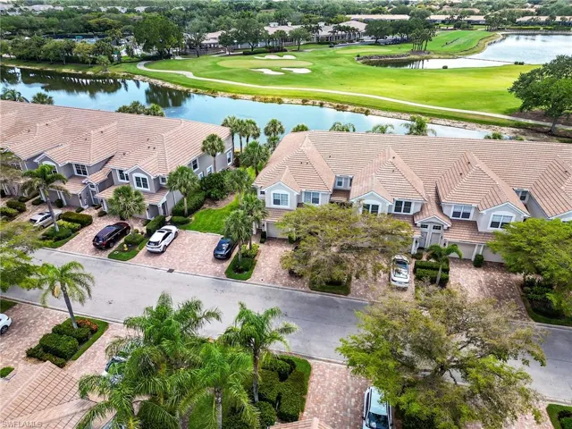Drone / aerial view with view of golf course, a water view, and a residential view