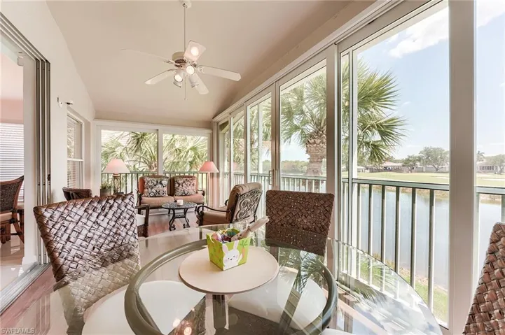 Sunroom / solarium with lofted ceiling and a water view