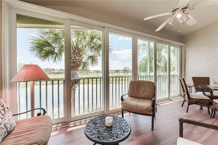 Sunroom featuring a water view
