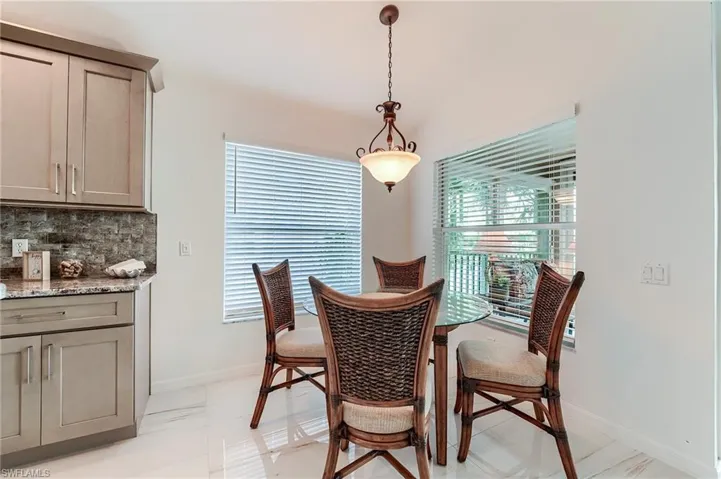Dining space featuring vaulted ceiling and baseboards