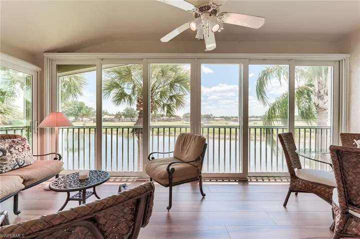 Sunroom with a wealth of natural light and a water view
